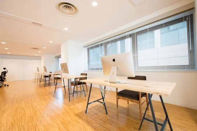 Creators’ desks facing the wall