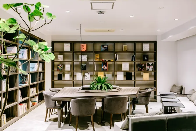 A shared table by the bookshelves